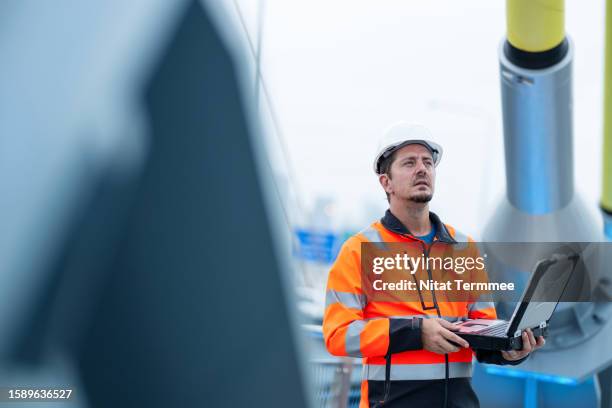 civil engineers improve infrastructure sustainability using smart construction management solution. a civil engineer working in a suspension bridge construction to check the durability of a cable-stayed bridge by using smart construction field software. - leading people across a bridge stock pictures, royalty-free photos & images