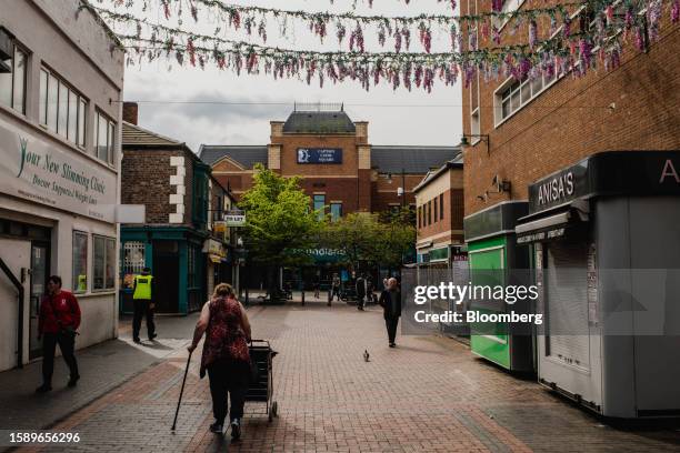 Security guard and pedestrians near Captain Cook Square in the town centre of Middlesbrough, UK, on Wednesday, May 17, 2023. While the UK isn't alone...