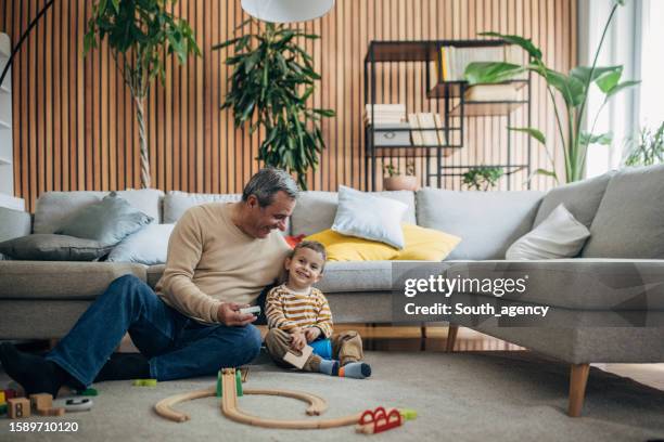 boy and grandfather playing together - grandson stock pictures, royalty-free photos & images