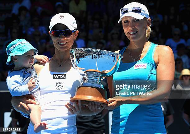 Cara Black of Zimbabwe with her son Lachlan and Anastasia Rodionova of Australia pose with the trophy following their doubles final against Julia...