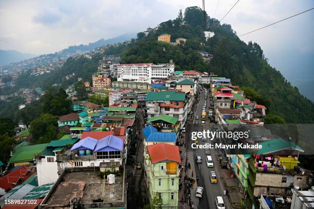 high angle view of townscape and mountains against sky, gangtok, sikkim - gangtok stock pictures, royalty-free photos & images