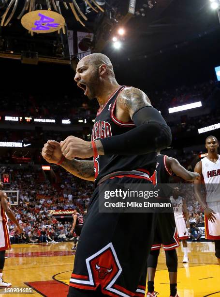 Carlos Boozer of the Chicago Bulls reacts to a three point play during a game against the Miami Heat at American Airlines Arena on January 4, 2013 in...