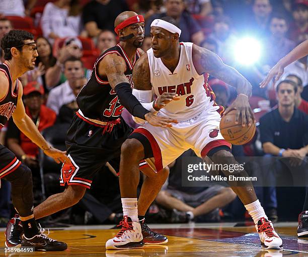 LeBron James of the Miami Heat posts up Richard Hamilton of the Chicago Bulls during a game at AmericanAirlines Arena on January 4, 2013 in Miami,...