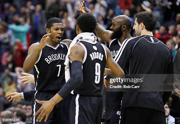 Joe Johnson of the Brooklyn Nets celebrates with teammates after hitting the game winning shot in double overtime to give the Nets a 115-113 win over...