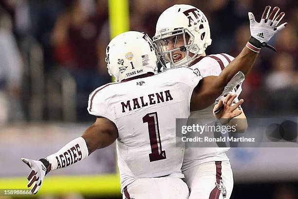 Johnny Manziel of the Texas A&M Aggies celebrates a touchdown with Ben Malena against the Oklahoma Sooners during the Cotton Bowl at Cowboys Stadium...