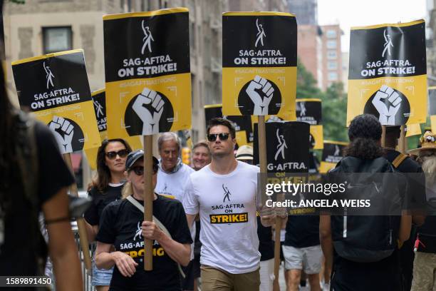 Italia Ricci and Robbie Amell join SAG-AFTRA members on the picket line outside of Warner Bros. Discovery on August 10, 2023 in New York. WGA members...