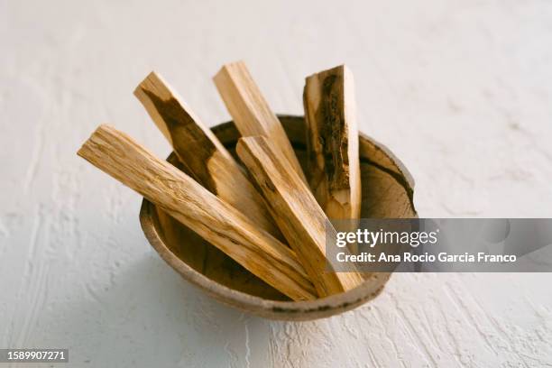 sticks of the sacred wood of palo santo tree in a coconut bowl - olibanum bildbanksfoton och bilder