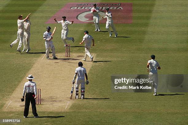 Jackson Bird of Australia celebrates with his team mates after taking the wicket of Dimuth Karunaratne of Sri Lanka during day three of the Third...