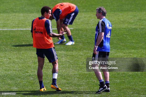 Head coach Jens Keller talks to Jermaine Jones during a Schalke 04 training session at the ASPIRE Academy for Sports Excellence on January 5, 2013 in...