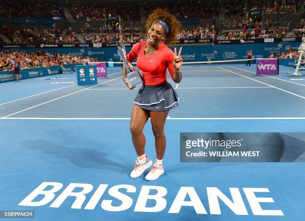 Serena Williams of the US celebrates with the trophy after defeating Anastasia Pavlyuchenkova of Russia in the final at the Brisbane International...
