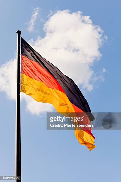 waving german flag and cloud - bandiera tedesca foto e immagini stock