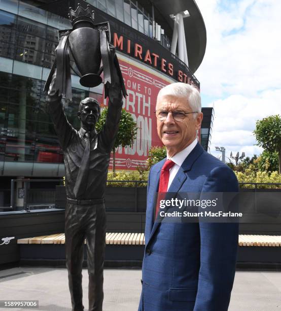 Former Arsenal manager Arsene Wenger with his recently unveiled statue at Emirates Stadium on August 03, 2023 in London, England.
