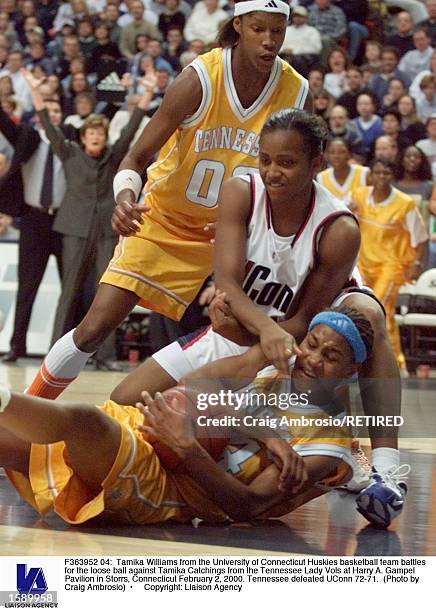 Tamika Williams from the University of Connecticut Huskies basketball team battles for the loose ball against Tamika Catchings from the Tennessee...