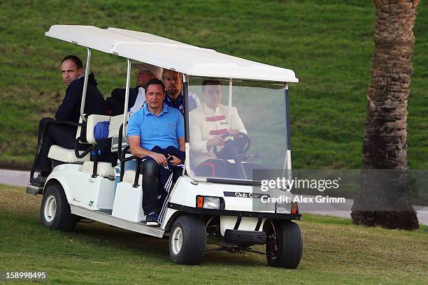 Manager Horst Heldt arrives in a golf cart for a Schalke 04 training session at the ASPIRE Academy for Sports Excellence on January 5, 2013 in Doha,...