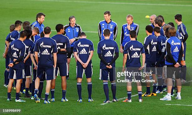 Head coach Jens Keller talks to the players during a Schalke 04 training session at the ASPIRE Academy for Sports Excellence on January 5, 2013 in...