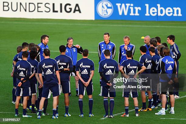 Head coach Jens Keller talks to the players during a Schalke 04 training session at the ASPIRE Academy for Sports Excellence on January 5, 2013 in...