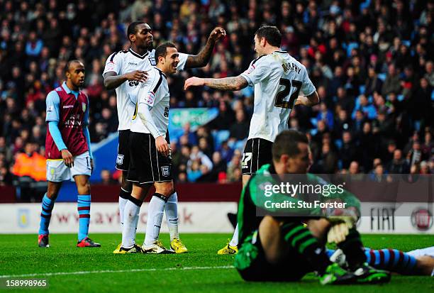 Jay Emmanuel-Thomas, Michael Chopra and Daryl Murphy of Ipswich Town celebrate as Eric Lichaj of Aston Villa scores an own goal as Shay Given of...