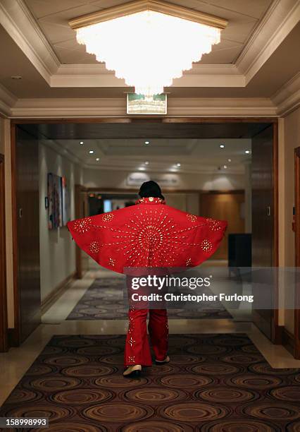 Elvis tribute artist Pat David Bishop poses as he waits to perform during the European Elvis Championships at the Hilton Hotel on January 5, 2013 in...