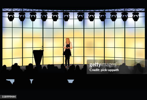 woman presenting detailed - in front of stock illustrations