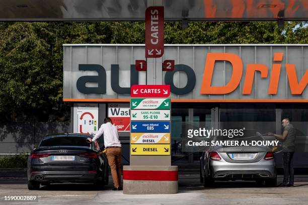 Motorists fill their cars at a Total Energies petrol station in Faches-Thumesnil near Lille, northern France on August 10, 2023.