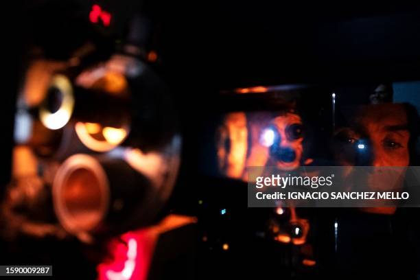 View of the 35mm projector during a screening of Christopher Nolan's "Oppenheimer" at the Cinemateca Uruguaya cinematheque in Montevideo, on August...