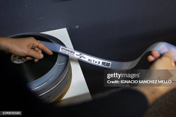 Projectionist Martin Ramirez prepares a film reel of Christopher Nolan's "Oppenheimer" before its screening at the Cinemateca Uruguaya cinematheque...