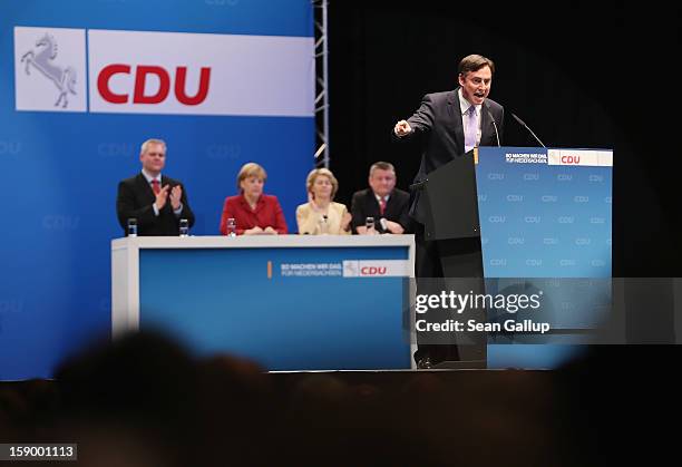 Lower Saxony Governor and German Christian Democrats incumbent candidate David McAllister speaks to supporters as German Chancellor and CDU...