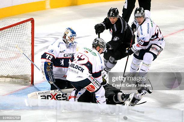 Goalie Rob Zepp , T. J. Mulock of Berlin of Berlin and Jens Baxmann of Berlin are challenged by Yasin Ehliz of Nuremberg and Eric Chouinard of...