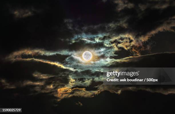 low angle view of moon against sky at night - full moon stock pictures, royalty-free photos & images