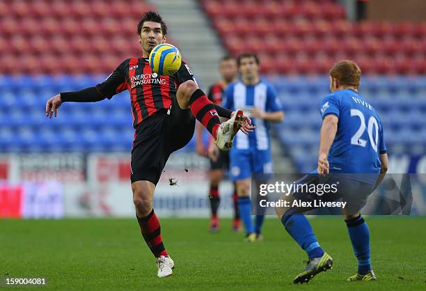 Richard Hughes of AFC Bournemouth cuts a pass out from Fraser Fyvie of Wigan Athletic during the Budweiser FA Cup Third Round match between Wigan...