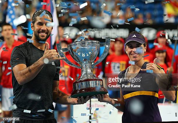 Fernando Verdasco and Anabel Medina Garrigues of Spain celebrate with the trophy after defeating Novak Djokovic and Ana Ivanovic of Serbia in the...