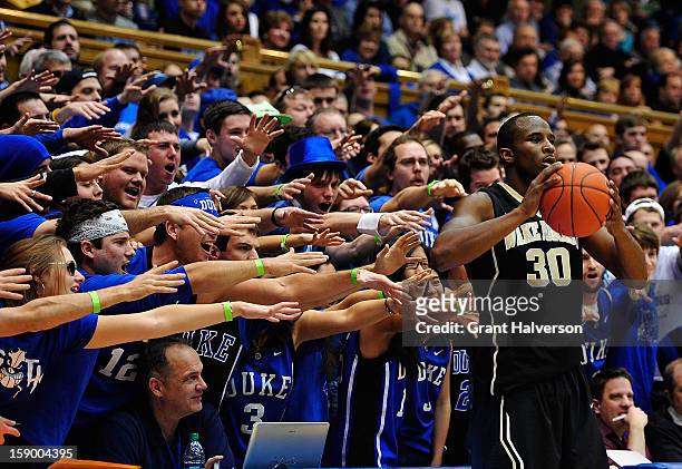 Duke Blue Devils fans taunt Travis McKie of the Wake Forest Demon Deacons as he prepares to inbound the ball during play at Cameron Indoor Stadium on...