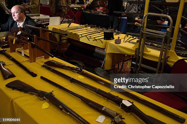 Stuart English of Milford, New Hampshire, sells antique guns at a gun show at the Crowne Plaza Hotel on January 5, 2013 in Stamford, Connecticut....