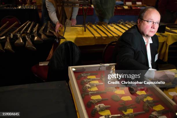 Stuart English of Milford, New Hampshire, sells antique guns at a gun show at the Crowne Plaza Hotel on January 5, 2013 in Stamford, Connecticut....