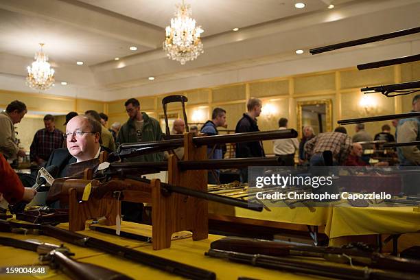 Stuart English of Milford, New Hampshire, sells antique guns at a gun show at the Crowne Plaza Hotel on January 5, 2013 in Stamford, Connecticut....