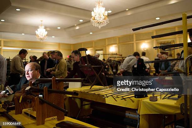 Stuart English of Milford, New Hampshire, sells antique guns at a gun show at the Crowne Plaza Hotel on January 5, 2013 in Stamford, Connecticut....