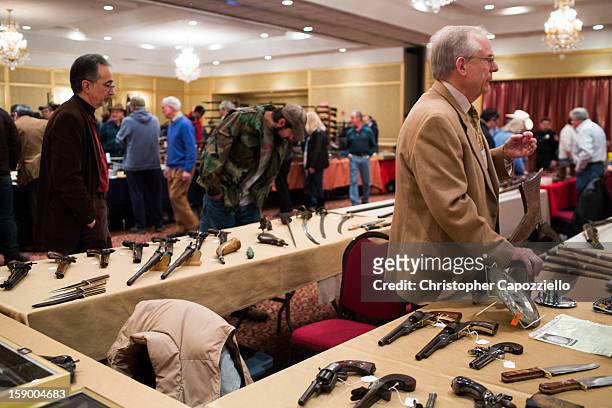 Dave Kleiner, of Gettysburg, Pennsylvania, sells antique guns at a gun show at the Crowne Plaza Hotel on January 5, 2013 in Stamford, Connecticut....