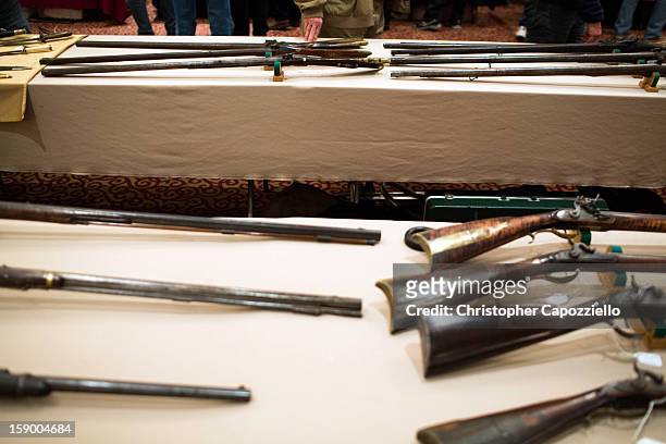Guns are displayed at a gun show held by Westchester Collectors Inc. At the Crowne Plaza Hotel on January 5, 2013 in Stamford, Connecticut. While...