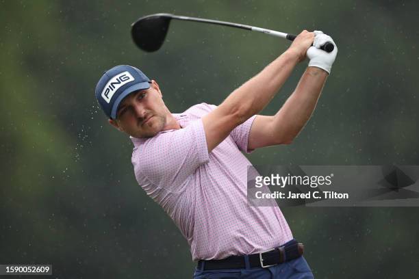 Austin Cook of the United States plays his shot from the 11th tee during the first round of the Wyndham Championship at Sedgefield Country Club on...