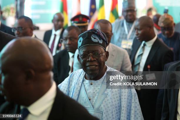 Chairperson of Economic Community of West African States and President of Nigeria Bola Ahmed Tinubu reacts after addressing ECOWAS Head of States and...