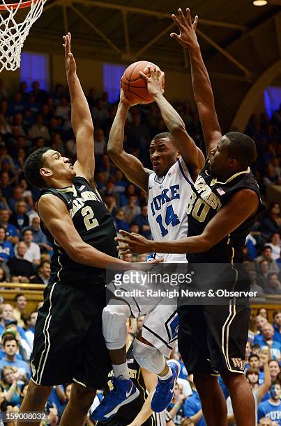 Duke guard Rasheed Sulaimon attempts a shot as Wake Forest forward Devin Thomas and forward Travis McKie defend in the second half at Cameron Indoor...