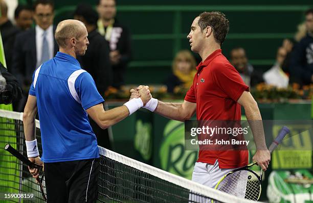 Richard Gasquet of France shakes hands with Nikolay Davydenko of Russia after the final in day six of the Qatar Open 2013 at the Khalifa...