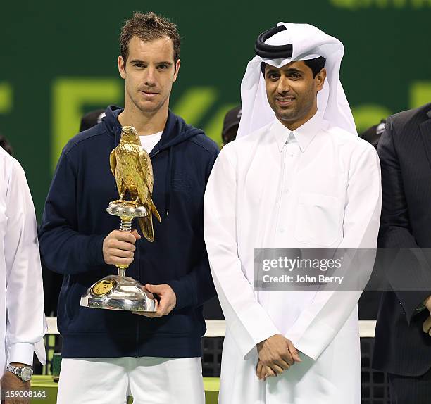 Richard Gasquet of France lifts the trophy and poses with Nasser Al-Khelaifi, President of the Qatar Tennis Federation and President of Paris...