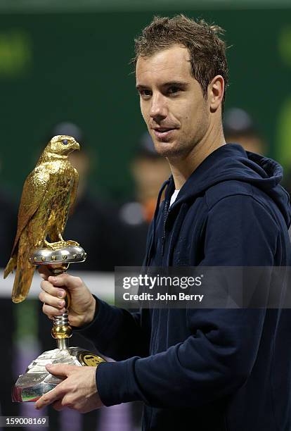 Richard Gasquet of France lifts the trophy after defeating in final Nikolay Davydenko of Russia in day six of the Qatar Open 2013 at the Khalifa...