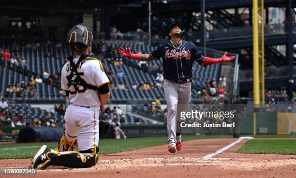 Orlando Arcia of the Atlanta Braves reacts as he rounds the bases after hitting a solo home run in the second inning during the game against the...