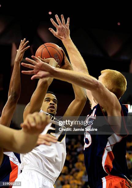 Laurence Bowers of the Missouri Tigers shoots over Joe Willman of the Bucknell Bison during the game at Mizzou Arena on January 5, 2013 in Columbia,...