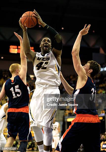 Alex Oriakhi of the Missouri Tigers of the Missouri Tigers shoots over Mike Muscala and Joe Willman of the Bucknell Bison during the game at Mizzou...