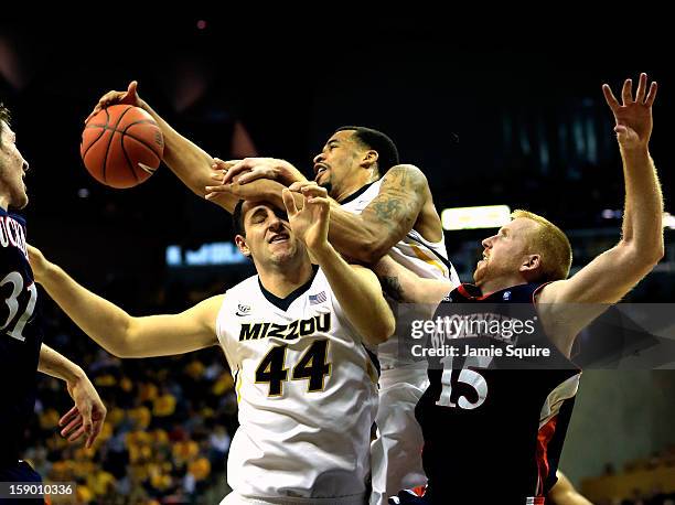 Laurence Bowers of the Missouri Tigers grabs a rebound over Ryan Rosburg and Joe Willman of the Bucknell Bison during the game at Mizzou Arena on...