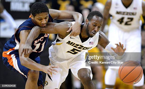 Missouri's Keion Bell, right, battles Bucknell's Ryan Hill for a loose ball in the first half at Mizzou Arena in Columbia, Missouri, Saturday,...