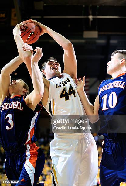 Ryan Rosburg of the Missouri Tigers grabs a rebound over Steven Kaspar and Brian Fitzpatrick of the Bucknell Bison during the game at Mizzou Arena on...